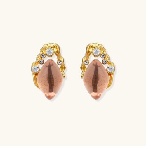 Gold-plated baroque stud earrings with coral-pink liuli stones and cubic zirconia crystals on white background.